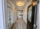 Inviting foyer with luxury vinyl plank flooring, transom windows, and white trim at 5849 Genesee Dr., Homesite 3, Durham, NC 27712