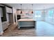 Modern kitchen featuring a large island, pendant lighting, and stainless steel appliances at 5849 Genesee Dr., Homesite 3, Durham, NC 27712