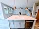 Open floor plan kitchen with island, stainless appliances, pendant lights, and view to the living room at 5849 Genesee Dr., Homesite 3, Durham, NC 27712