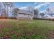 Exterior view of the home from the backyard showing brick foundation and side entrance at 589 Vinson Rd, Clayton, NC 27527