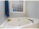 Bathroom featuring white tub and tile detail at 589 Vinson Rd, Clayton, NC 27527