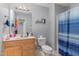 Bathroom featuring blue shower curtain and wood vanity at 589 Vinson Rd, Clayton, NC 27527