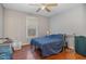 Bedroom with hardwood floors, ceiling fan, and a large window at 589 Vinson Rd, Clayton, NC 27527