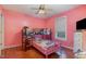 Cozy pink bedroom features bunk bed, window, and ceiling fan at 589 Vinson Rd, Clayton, NC 27527