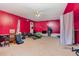 Red bedroom featuring carpeted floor and fan at 589 Vinson Rd, Clayton, NC 27527