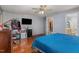 Bedroom with hardwood floors, ceiling fan, television, and attached bathroom view at 589 Vinson Rd, Clayton, NC 27527