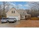 Charming two-story home with attached two car garage, front porch and mature trees at 589 Vinson Rd, Clayton, NC 27527