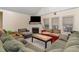 Living room featuring a fireplace, large windows and plush couches at 589 Vinson Rd, Clayton, NC 27527