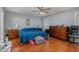Bedroom with blue bedding, hardwood floors, natural light and closet at 589 Vinson Rd, Clayton, NC 27527