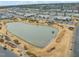 Aerial view of a community with a pond, landscaping, and community buildings, showcasing serene living at 5908 Giddings St, Raleigh, NC 27616