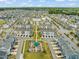 Aerial view of the community featuring a mix of townhomes, green spaces, and recreational areas at 5908 Giddings St, Raleigh, NC 27616