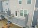 Up close look at a wooden back deck on a townhome with gray railings and a rear entry door at 5908 Giddings St, Raleigh, NC 27616