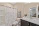 Clean bathroom featuring a shower with curtain, modern vanity, and stylish fixtures at 5908 Giddings St, Raleigh, NC 27616