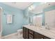 Bright bathroom with a double vanity, granite countertop, and white subway tile in the shower at 5908 Giddings St, Raleigh, NC 27616