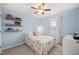 Comfortable bedroom with carpet, shelves, and a ceiling fan at 5908 Giddings St, Raleigh, NC 27616