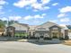 Commercial building exterior with a variety of shops and restaurants under a bright sky at 5908 Giddings St, Raleigh, NC 27616