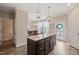 Open-concept kitchen featuring a central island with granite countertops and views into the dining area at 5908 Giddings St, Raleigh, NC 27616