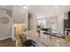 Charming kitchen featuring granite countertops, a stainless steel sink, and a breakfast bar with barstools at 5908 Giddings St, Raleigh, NC 27616