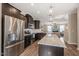 Modern kitchen featuring stainless steel appliances, a central island with granite countertops, and pendant lighting at 5908 Giddings St, Raleigh, NC 27616