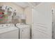 Well-organized laundry room with washer, dryer, wire shelving, and plenty of storage space at 5908 Giddings St, Raleigh, NC 27616