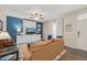 Cozy living room featuring blue accent wall, ceiling fan, and a comfortable sofa with natural light at 5908 Giddings St, Raleigh, NC 27616