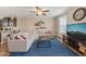 Inviting living room with a comfortable sectional, blue rug, and an open concept layout at 5908 Giddings St, Raleigh, NC 27616