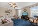 Cozy living room with a comfortable sectional sofa, a ceiling fan, and a large window at 5908 Giddings St, Raleigh, NC 27616
