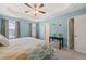 Spacious main bedroom with a tray ceiling, ceiling fan, carpet, and windows at 5908 Giddings St, Raleigh, NC 27616