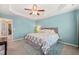 Spacious main bedroom with a tray ceiling, carpet, and cool-toned blue walls at 5908 Giddings St, Raleigh, NC 27616