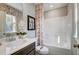 Bathroom showcasing a white vanity, large mirror, decorative art, and tub-shower combo at 67 Rice Road # 01, Zebulon, NC 27597