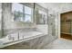 Luxurious bathroom featuring a soaking tub and a glass-enclosed shower at 67 Rice Road # 01, Zebulon, NC 27597