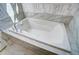 Clean white bathtub with chrome fixtures and tile surround at 67 Rice Road # 01, Zebulon, NC 27597