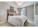 Bedroom with a large window offering plenty of natural light and views of the tree line outside at 67 Rice Road # 01, Zebulon, NC 27597