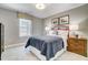 Bedroom features a cozy bed, decorative lamps, window with a patterned valance, and themed artwork at 67 Rice Road # 01, Zebulon, NC 27597