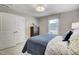 Bedroom features a patterned valance, comfy bed, closet with double doors, dresser, and decorative accents at 67 Rice Road # 01, Zebulon, NC 27597