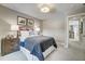 Neutral bedroom features a comfy bed, a nightstand with a lamp, and a door leading to the hallway at 67 Rice Road # 01, Zebulon, NC 27597