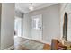 Bright entryway with hardwood floors, white trim, a patterned rug, and a door with glass panes at 67 Rice Road # 01, Zebulon, NC 27597