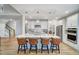 Open concept kitchen with island, pendant lights, stainless steel appliances and hardwood floors at 67 Rice Road # 01, Zebulon, NC 27597