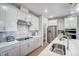 Modern kitchen with white cabinets, stainless steel appliances, and a stylish backsplash at 67 Rice Road # 01, Zebulon, NC 27597