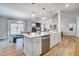 Open concept kitchen with stainless steel appliances, white cabinets, and adjoining dining area at 67 Rice Road # 01, Zebulon, NC 27597