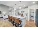 Elegant kitchen with large island, bar stool seating and an open view of the living room and staircase at 67 Rice Road # 01, Zebulon, NC 27597
