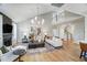 Bright living room boasts hardwood floors, fireplace, modern lighting and vaulted ceilings at 67 Rice Road # 01, Zebulon, NC 27597