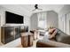 Comfortable living room with large TV, unique wood tables, and a cozy couch with window views at 67 Rice Road # 01, Zebulon, NC 27597