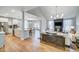 Open concept living room and kitchen with hardwood floors, stainless appliances, and lots of natural light at 67 Rice Road # 01, Zebulon, NC 27597