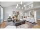 Bright living room featuring soaring ceilings, neutral furniture, and a modern chandelier at 67 Rice Road # 01, Zebulon, NC 27597