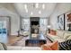 Bright living room featuring a fireplace with mounted TV, neutral furniture, and a modern light fixture at 67 Rice Road # 01, Zebulon, NC 27597