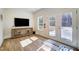 Bright lobby with a modern console, TV, and double doors to the outside at 67 Rice Road # 01, Zebulon, NC 27597
