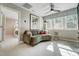 Comfortable loft with a curved couch, large window, and stylish lighting at 67 Rice Road # 01, Zebulon, NC 27597