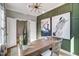 Well-appointed office with green walls, stylish furniture, and ample natural light at 67 Rice Road # 01, Zebulon, NC 27597