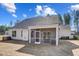 Backyard view featuring screened porch, gray siding, and mature trees, creating a serene outdoor retreat at 67 Rice Road # 01, Zebulon, NC 27597